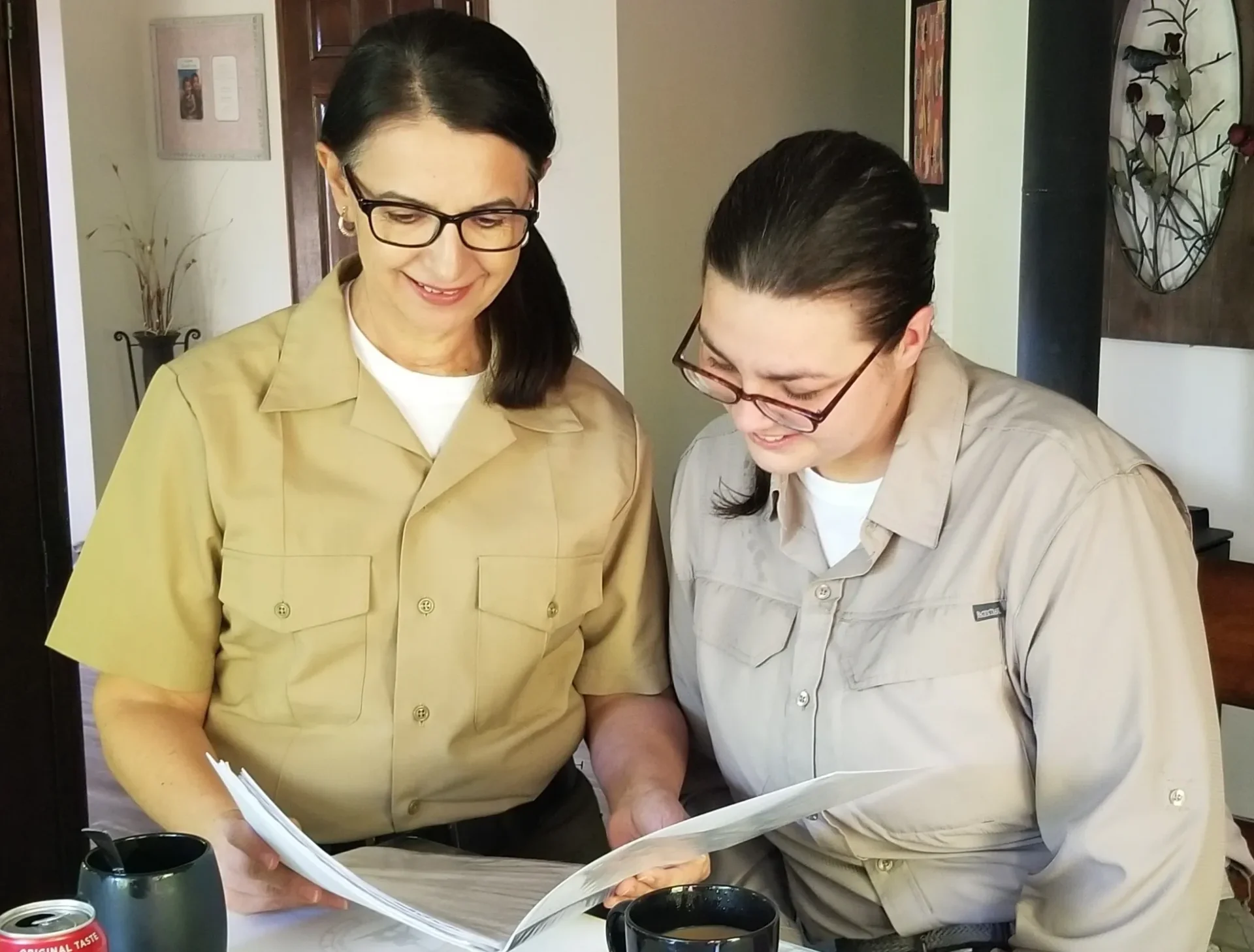 Two women looking at a book together.