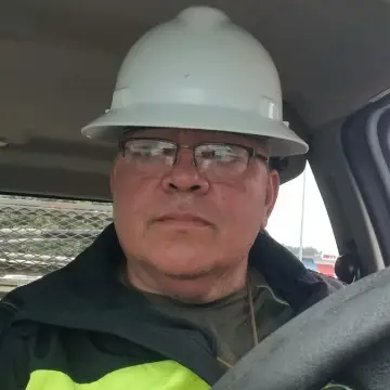 A man in a hard hat and jacket.